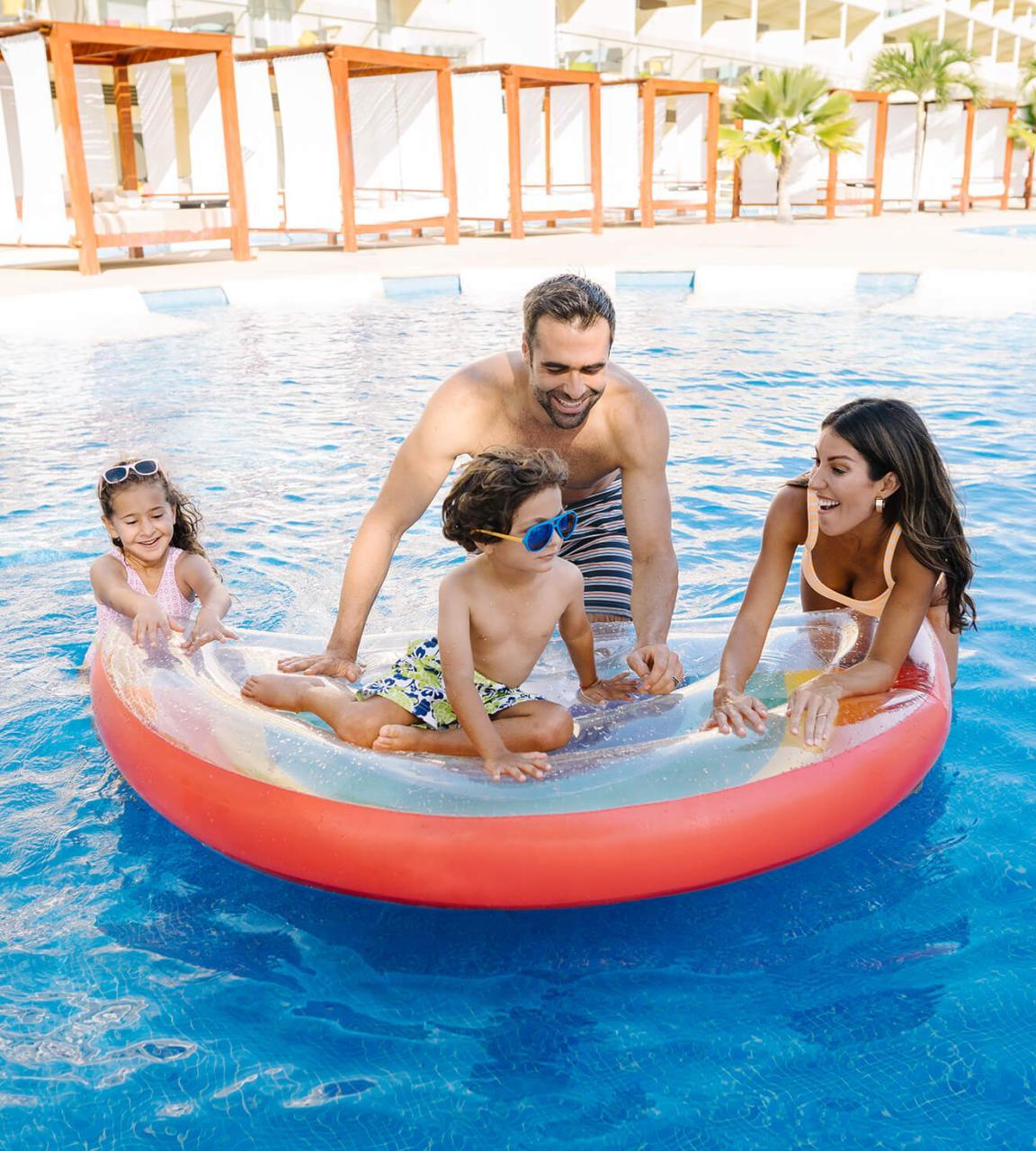 family in floaty in pool