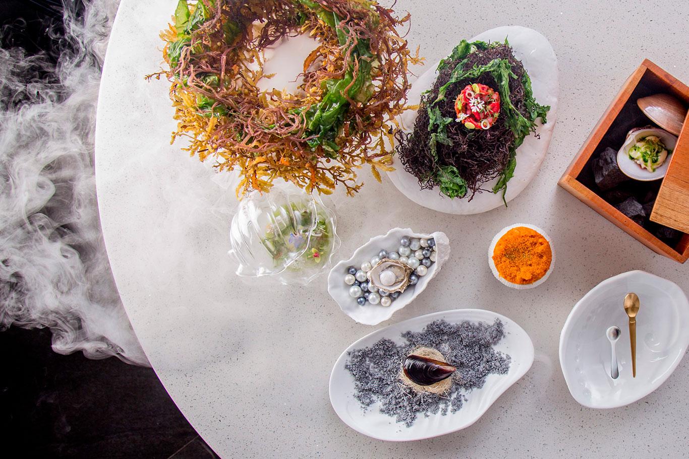 Table with exotic gourmet dishes
