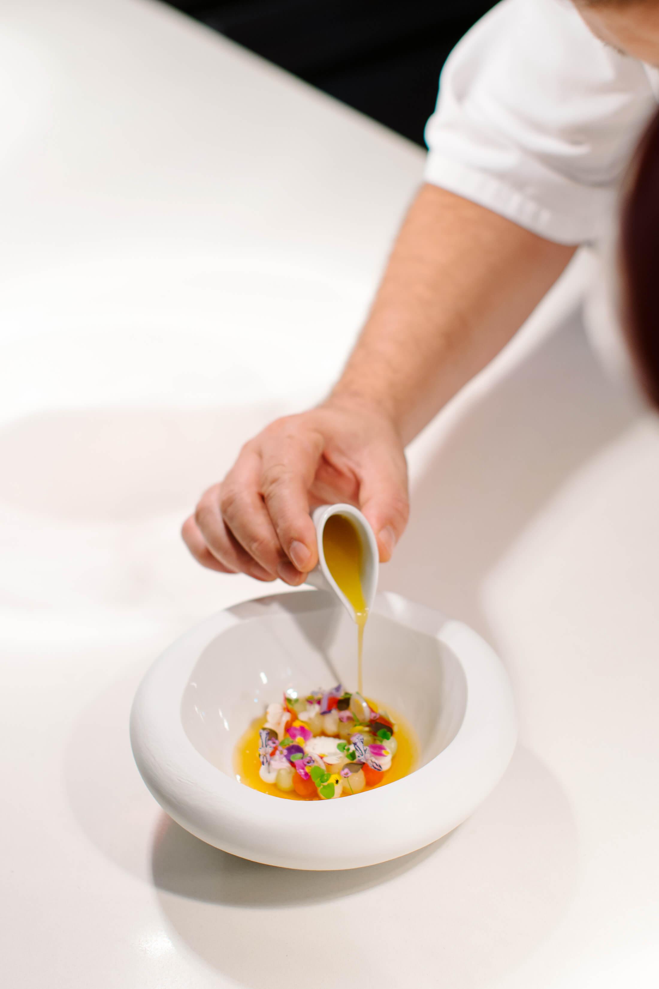 A dish being plated at Le Chique