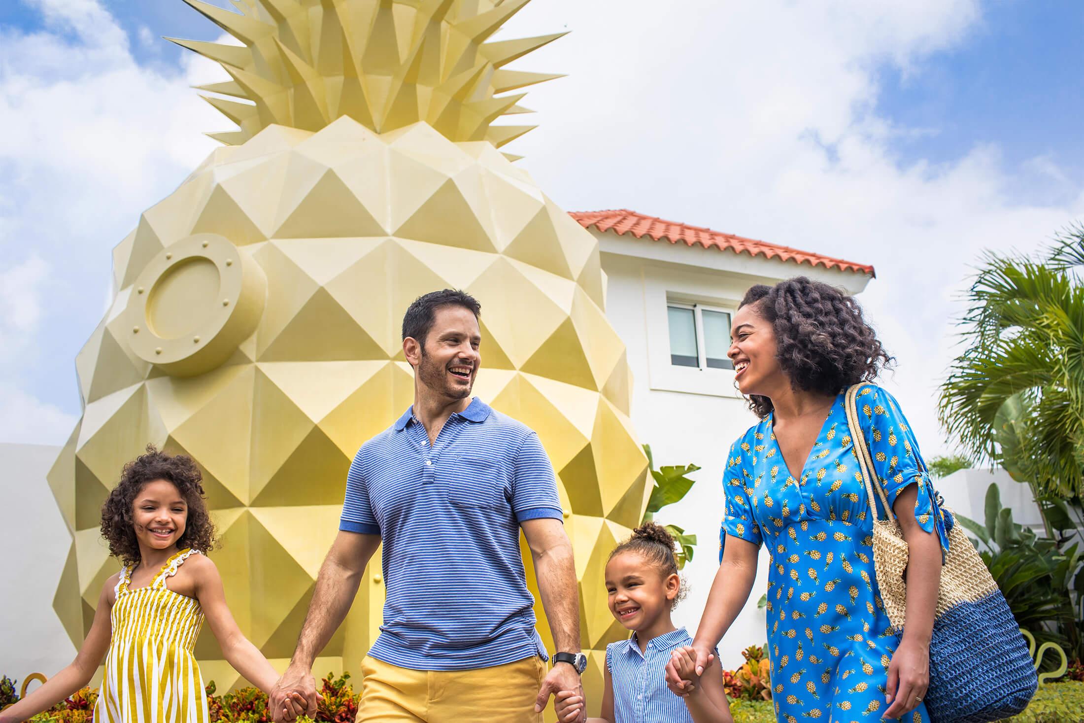 Family in front of a giant pineapple