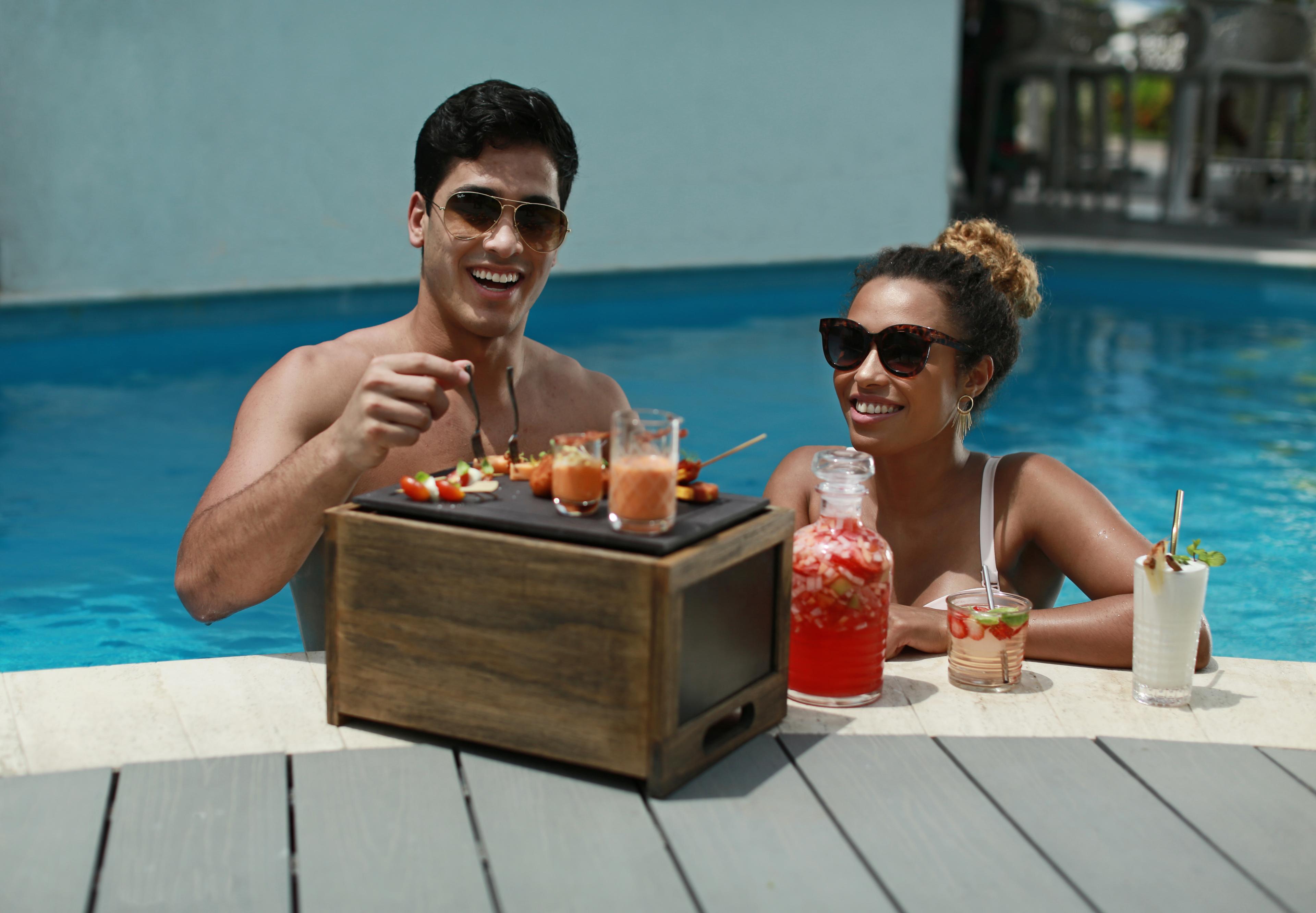 couple eating by pool edge