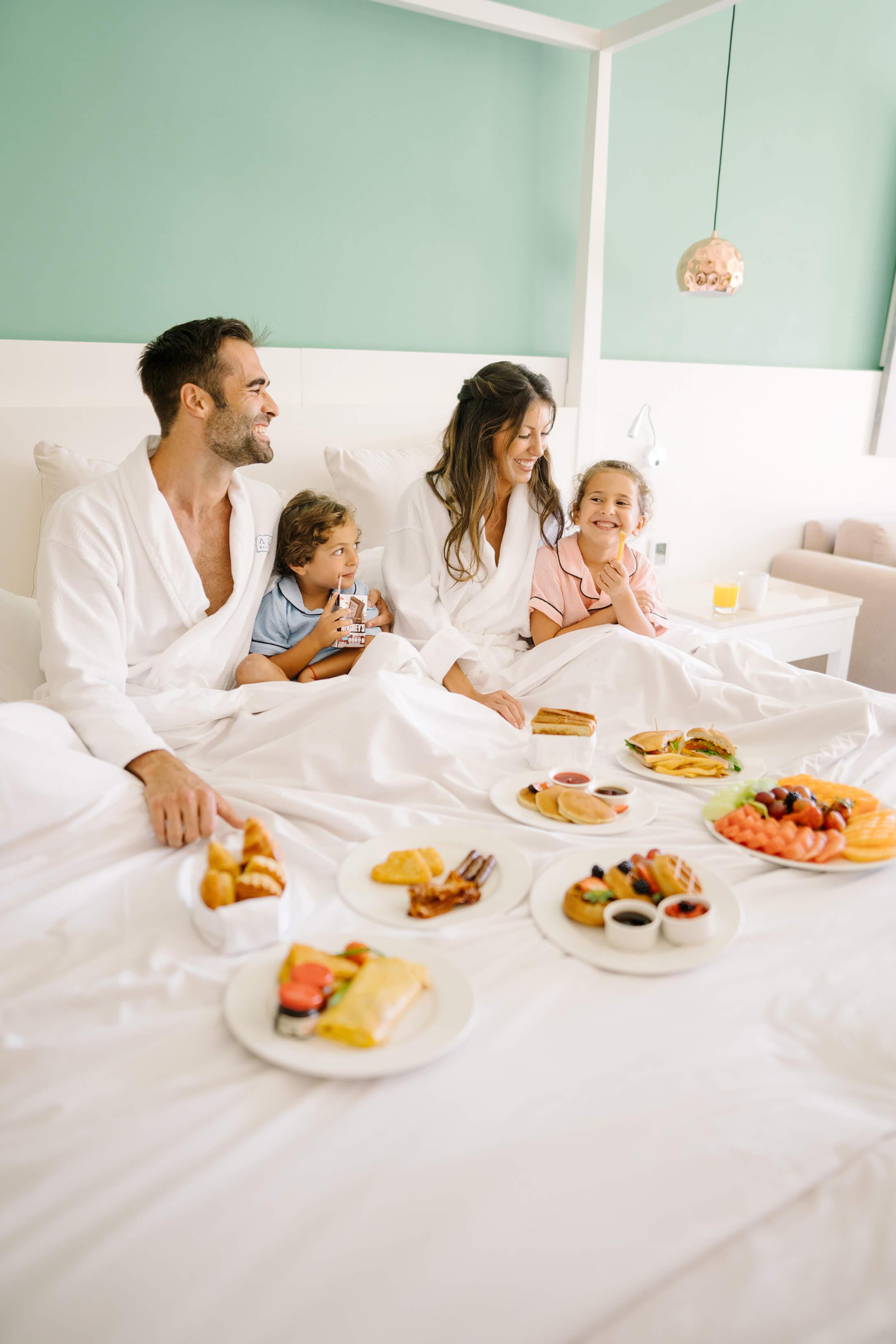 family eating breakfast in bed