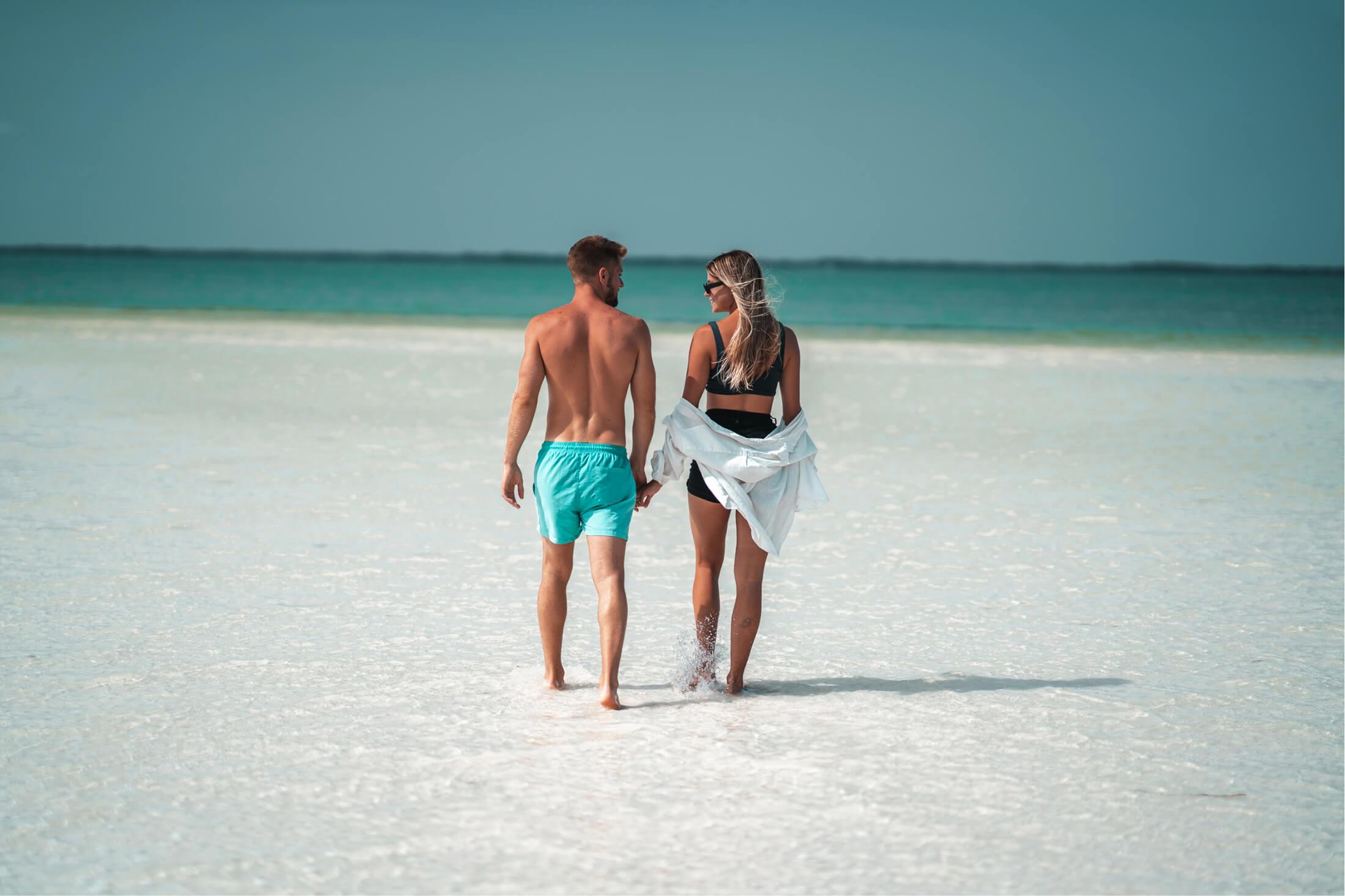 Couple walking along beach