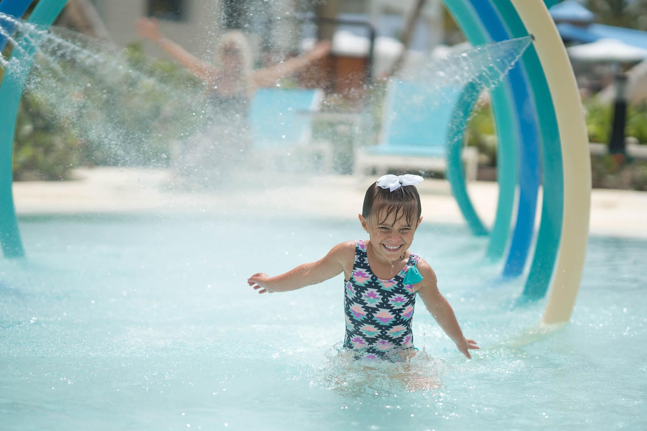 A kid splashing in a Margaritaville resort pool