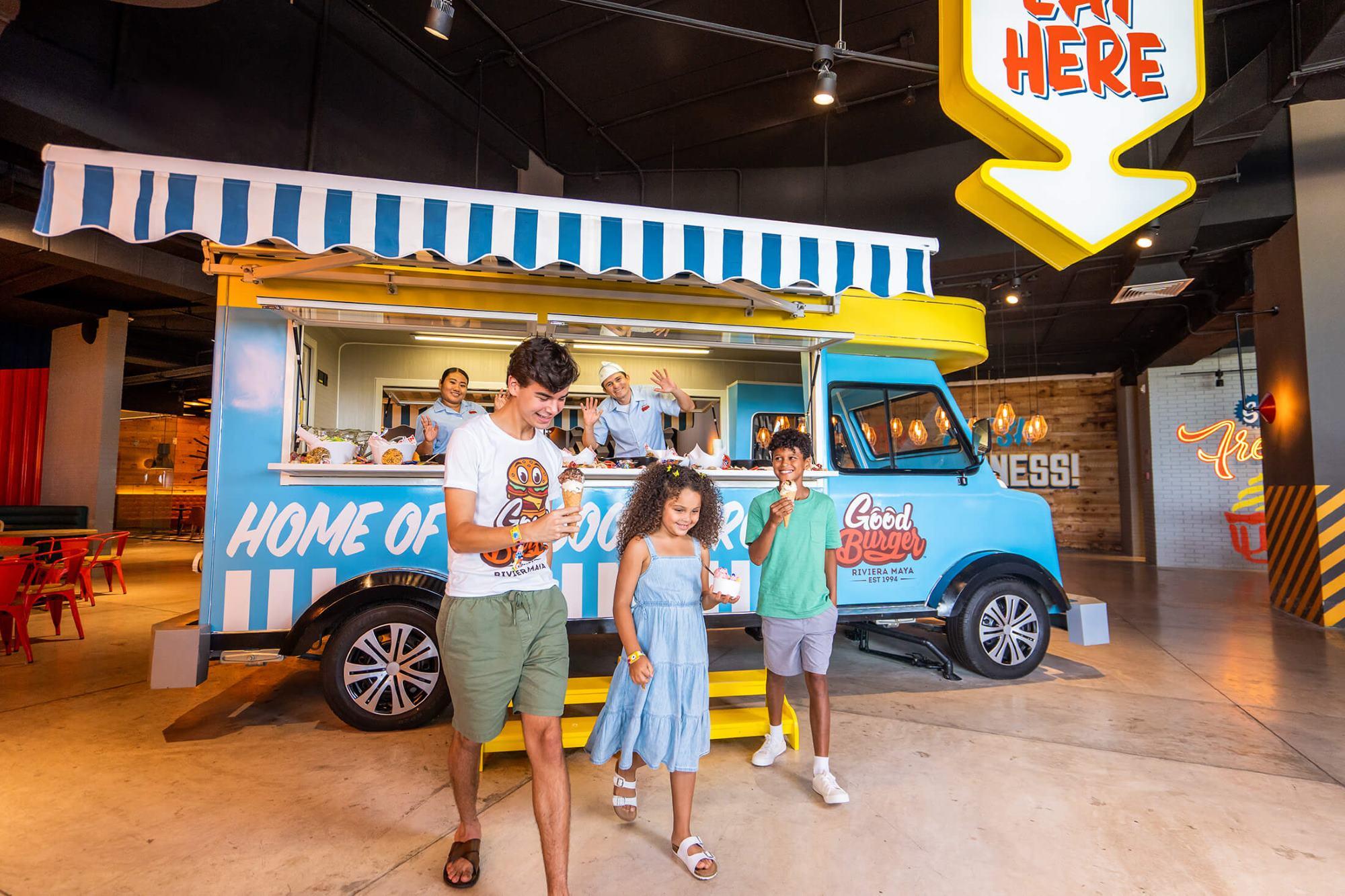 A family gets some food from the Good Burger truck