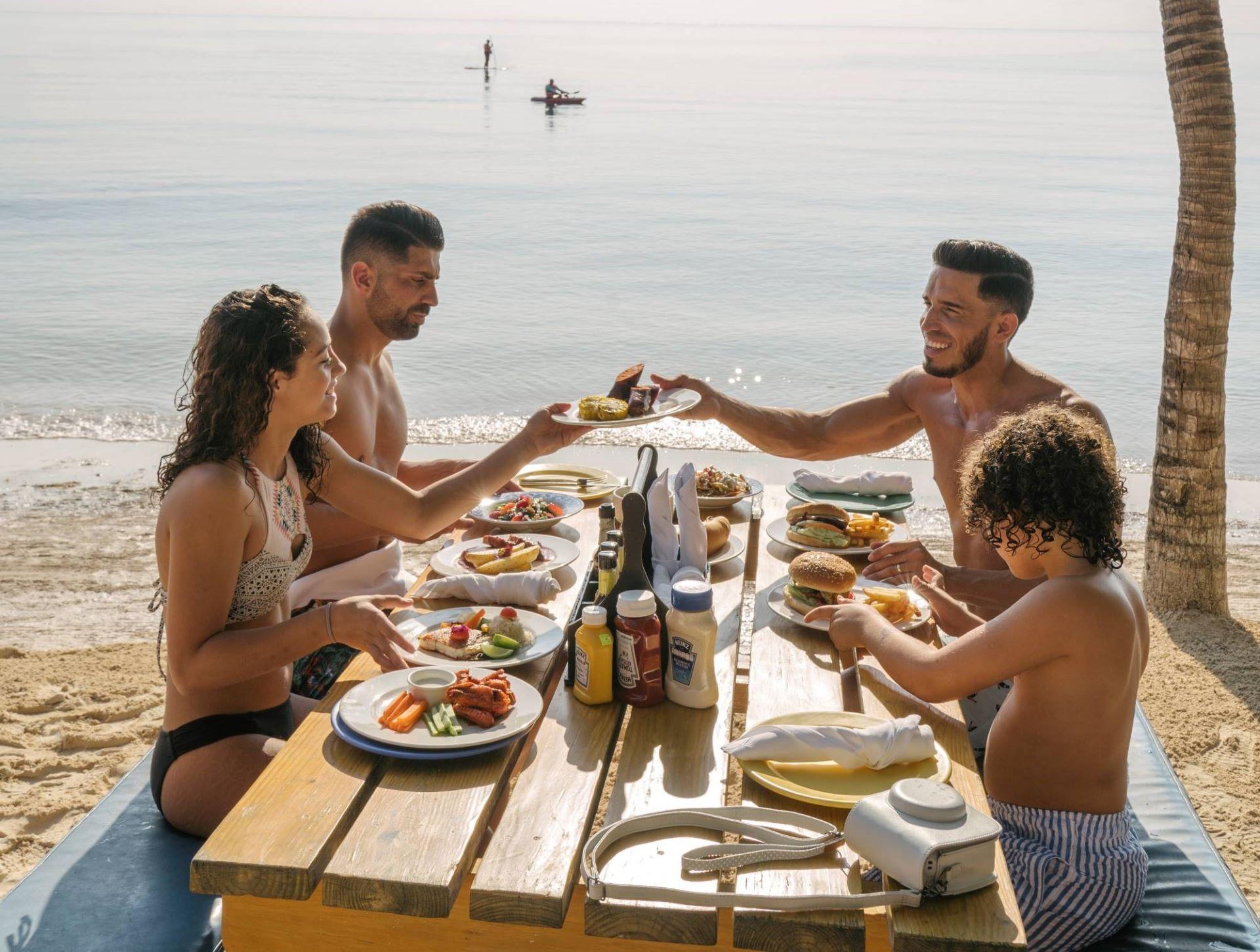 family eating in the beach