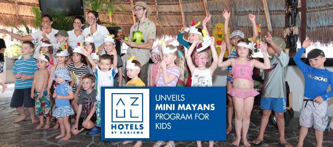 Large group of children raising their hands