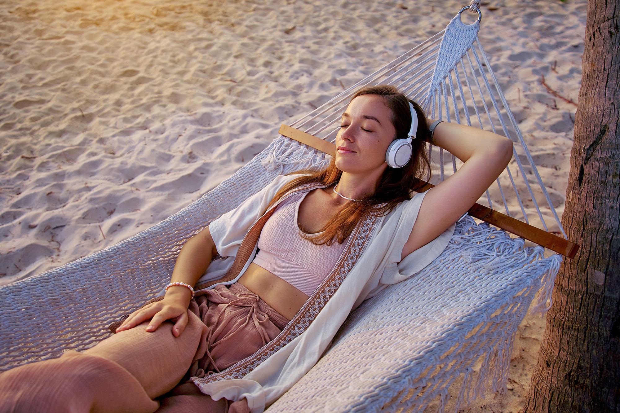 Girl at the beach listening music
