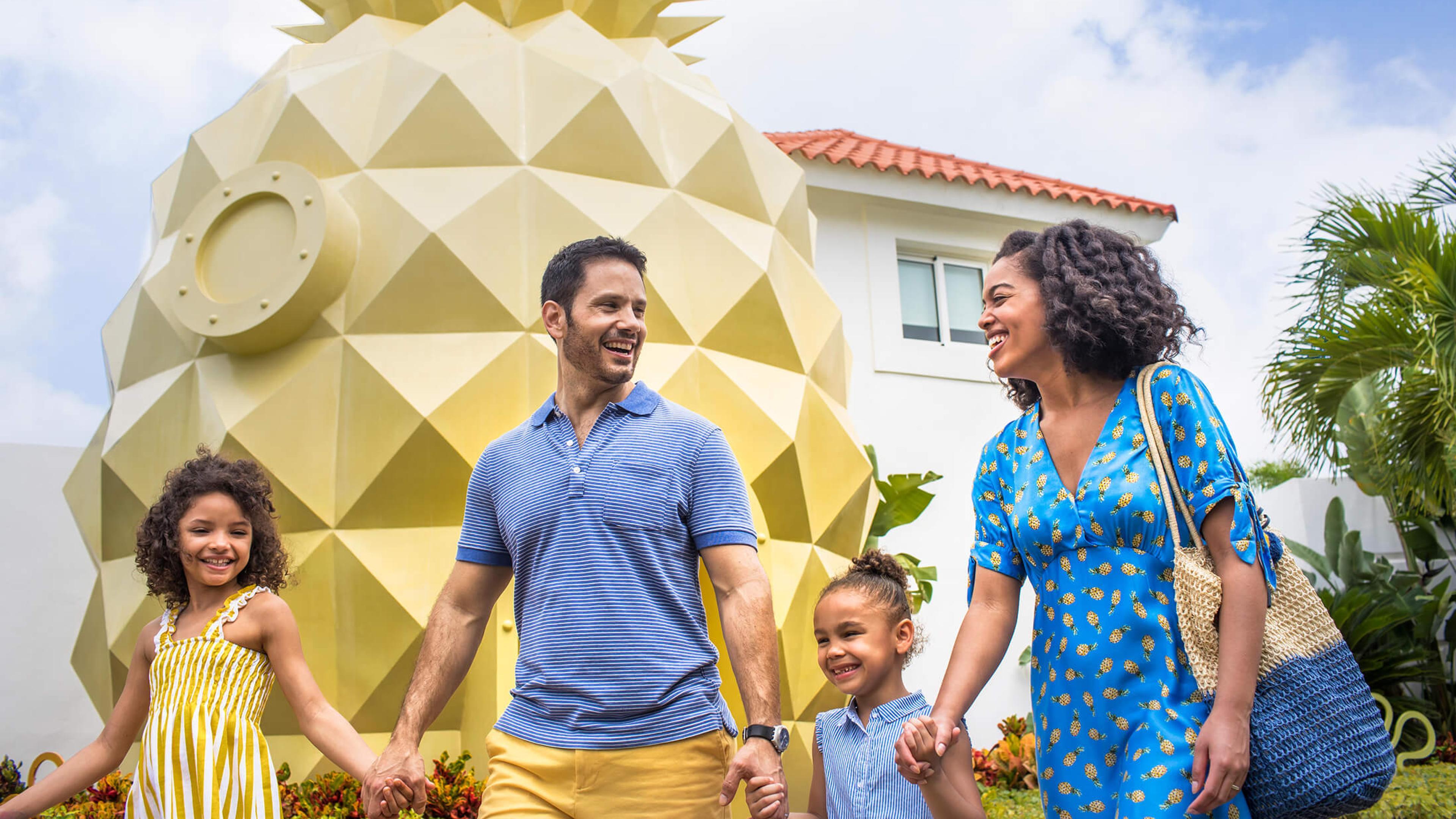A family walks through the Pineapple Villa