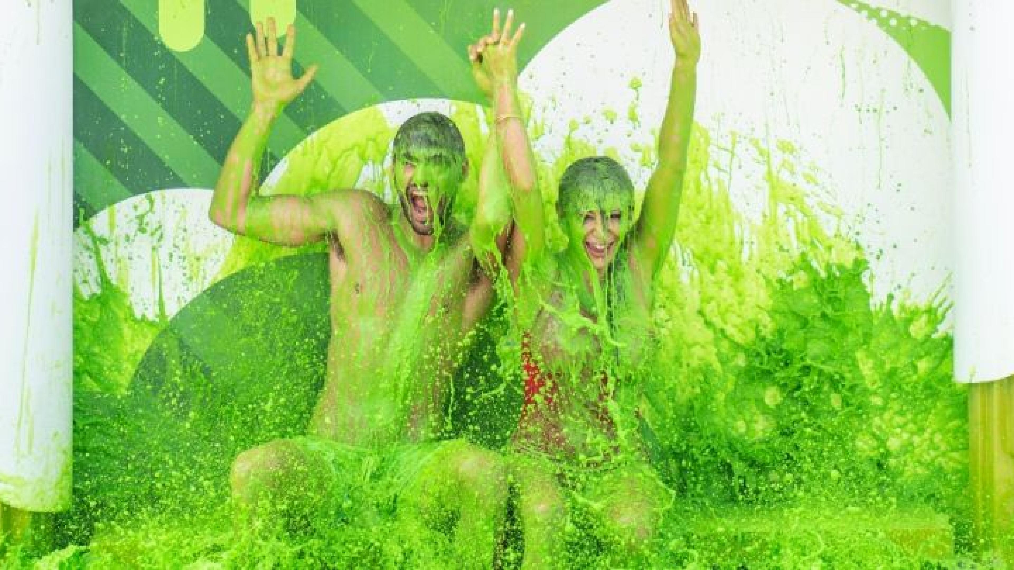A couple getting covered in green slime
